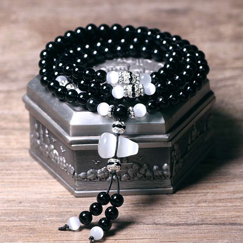Armband Weißer Kristall Schwarzer Onyx mit silbernen Verzierungen elegantes Design.