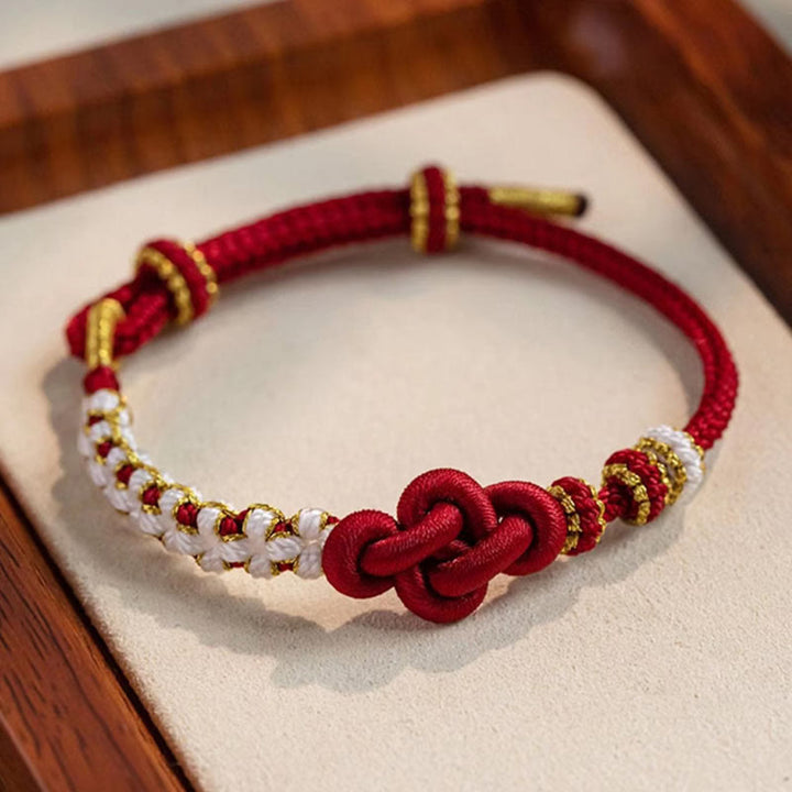 Armband Pfirsichblüte rotes Seidengeflecht goldene Perlen elegant elegant