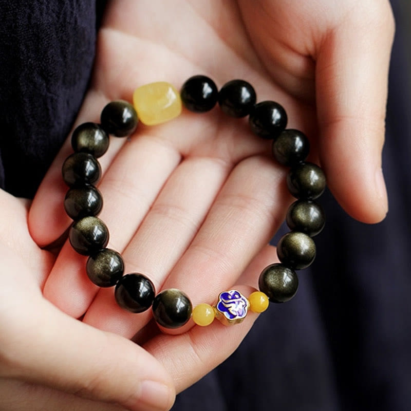 Schwarzes Obsidian Armband mit gelben Achat Perlen und chinesischem Amulett Handgelenk.