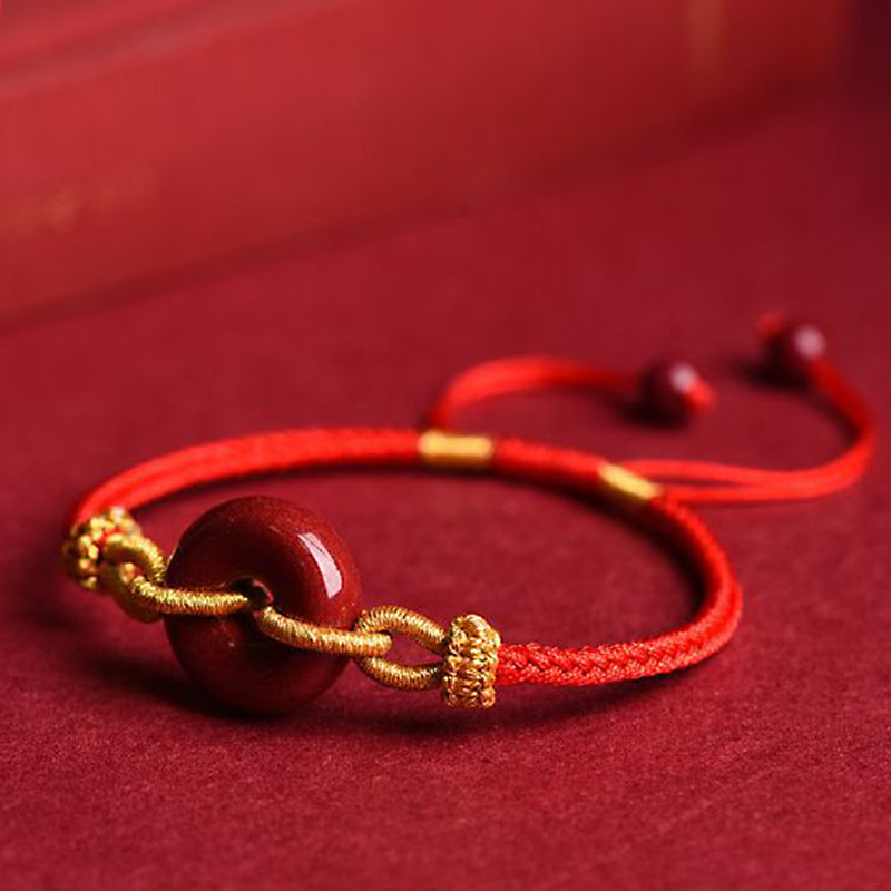 Armband Zinnober – Frieden & Segen Energie rotes Seidenband goldene Perlen