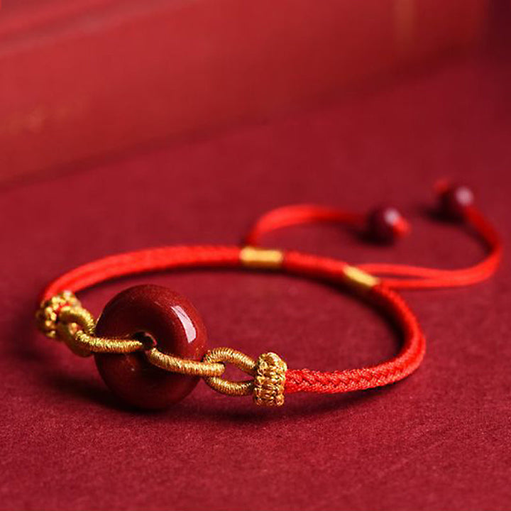 Armband Zinnober – Frieden & Segen Energie rotes Seidenband goldene Perlen