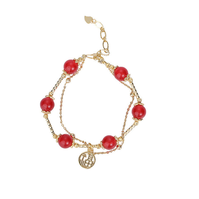 Armband Roter Achat Fu-Zeichen mit goldenen Kettengliedern und Anhänger.