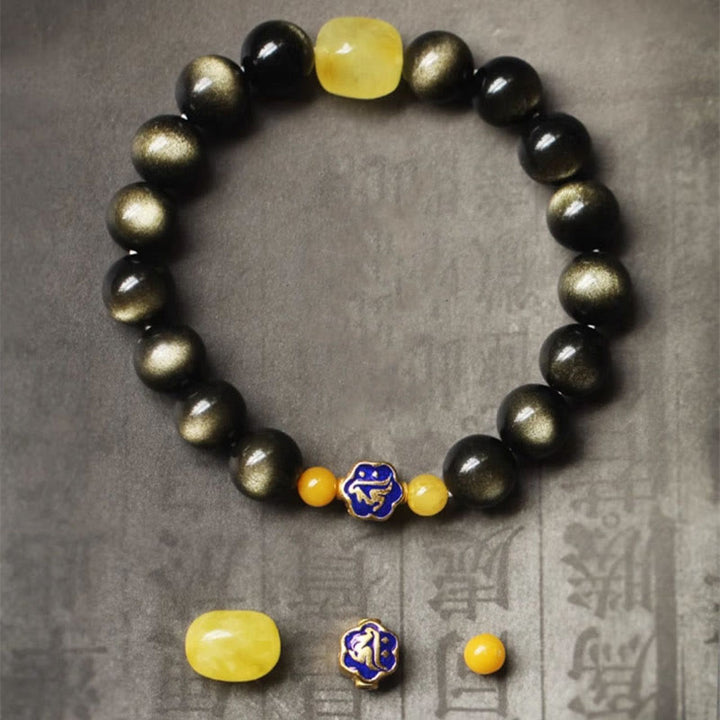 Schwarzes Obsidian Armband mit gelbem Stein und chinesischem Tierkreis Anhänger.