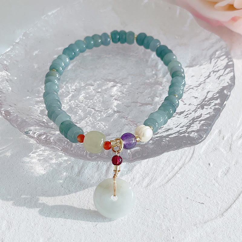 Armband mit Erdbeerquarz Perle und Fu-Zeichen Anhänger Glück.