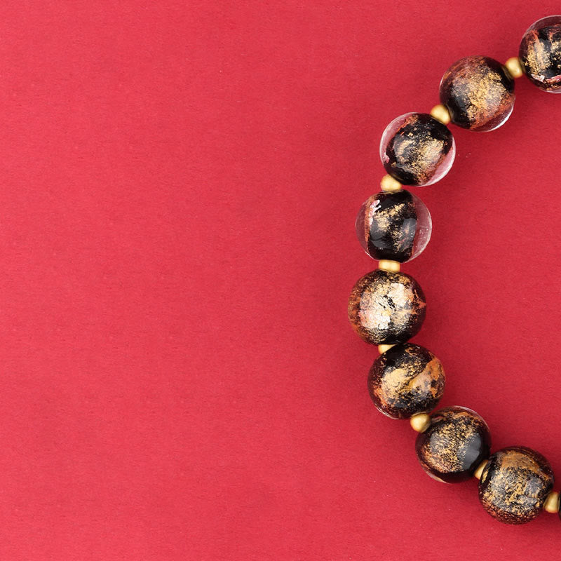Armband Om Mani Padme Hum – Glück schwarze goldglitzernde Perlen elastisch