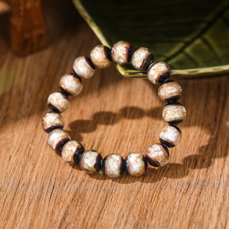 Armband Classic – Glück & Wohlstand aus bronzefarbenen Perlen elastisch getragen