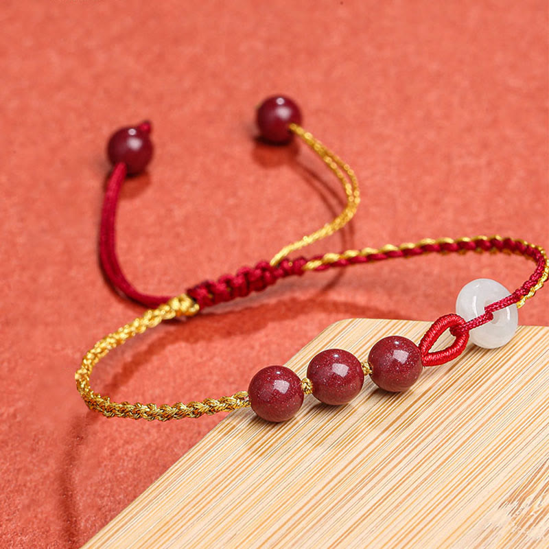 Armband Zinnober Jade mit roten Perlen Goldseide verstellbar elegant.