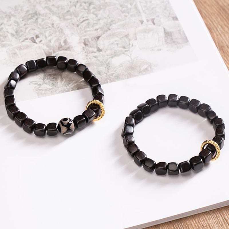 Armband Ebenholz Balance Ruhe schwarze Perlen Goldakzente elegant