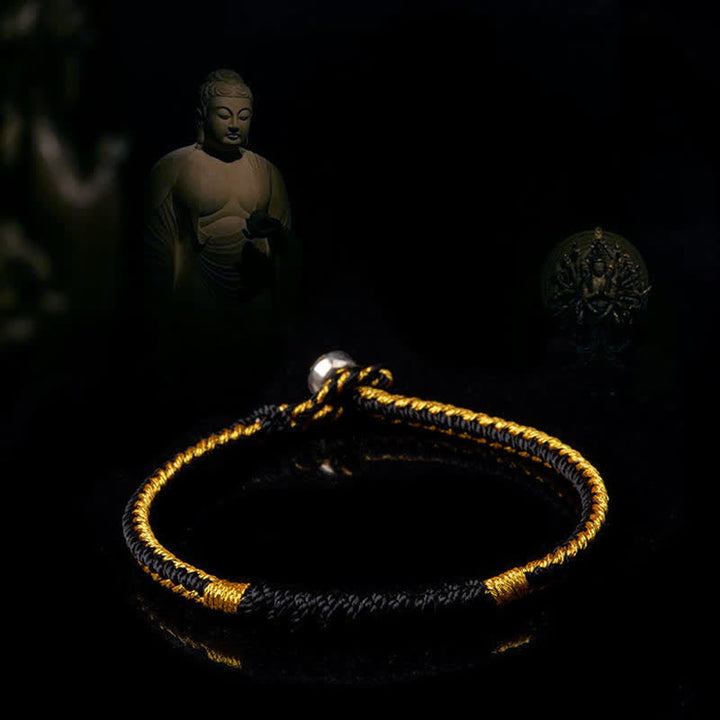 Armband – Schutz & Glück goldene Wicklung schwarzer Stoff Buddha Dekoration