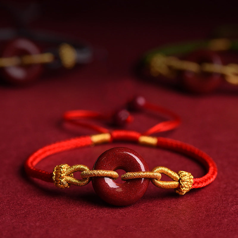 Armband Zinnober – Frieden & Segen Energie rotes Seidenband goldene Verzierungen