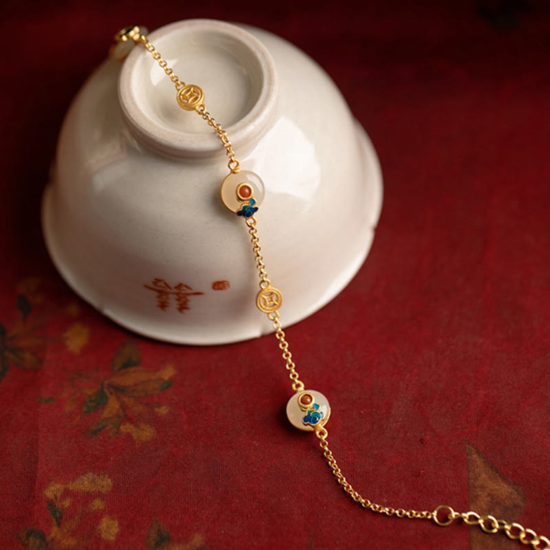 Goldenes Armband mit Jade-Perlen und glücksbringenden Symbolen elegant.