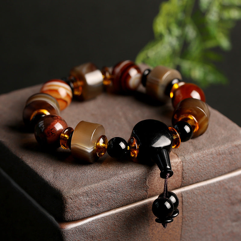 Armband Onyx – Glück Balance mit braunen Bernsteinperlen und schwarzem Onyx.