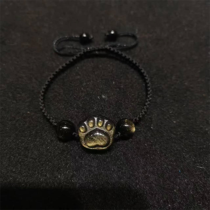 Schwarzes Obsidian Armband mit Katzenpfote Charm elastisch getragen