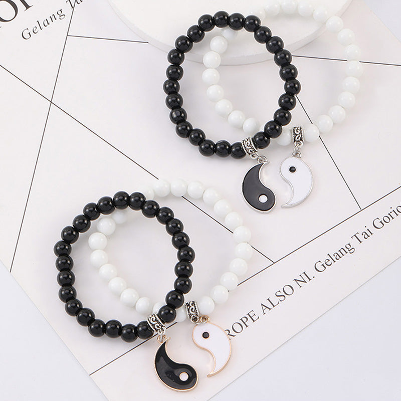 Zwei Yin-Yang-Armbänder mit schwarzem Onyx und weißen Perlen Flachlage