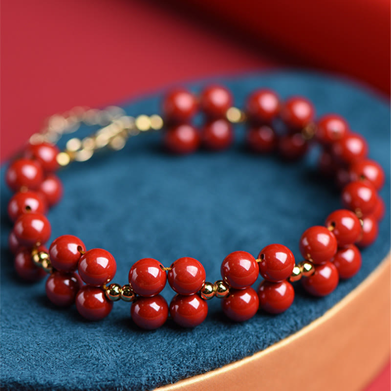 Armband Zinnober – Segen Harmonie rote Perlen Goldakzente elegant.