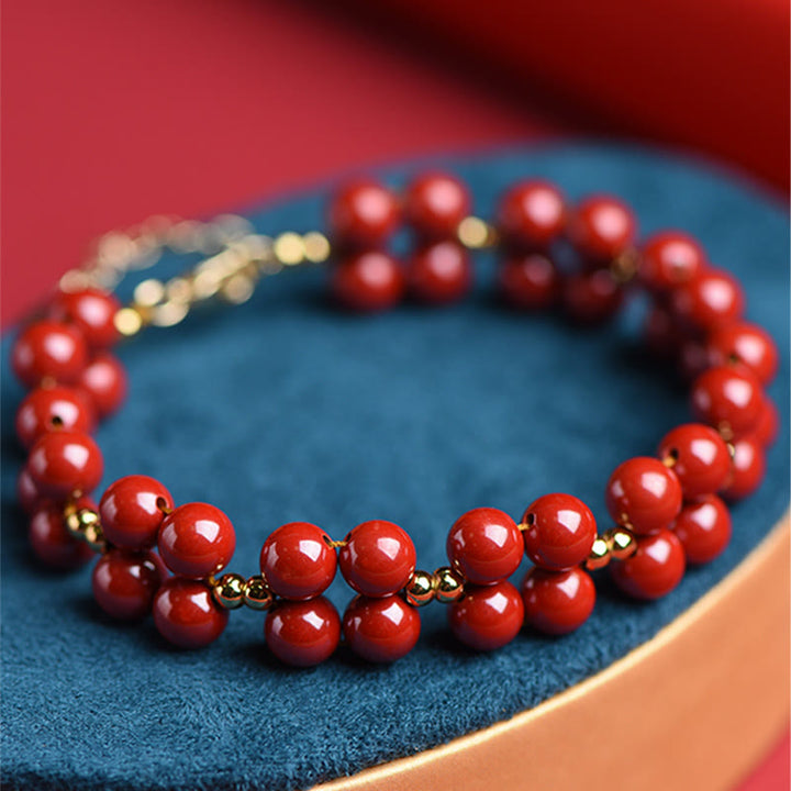 Armband Zinnober – Segen Harmonie rote Perlen Goldakzente elegant.