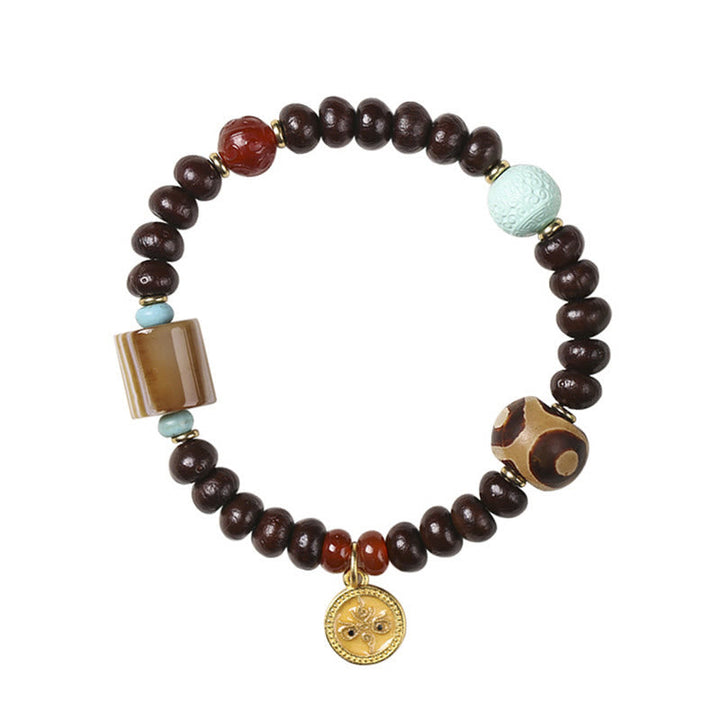 Bodhi Armband mit braunen Perlen, Türkis und Goldanhänger elegant.