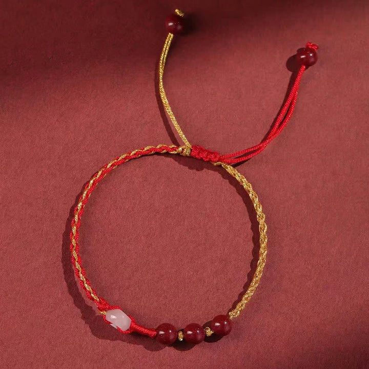 Armband Zinnober Jade – Frieden & Segen rotes goldenes Seil Perlen.