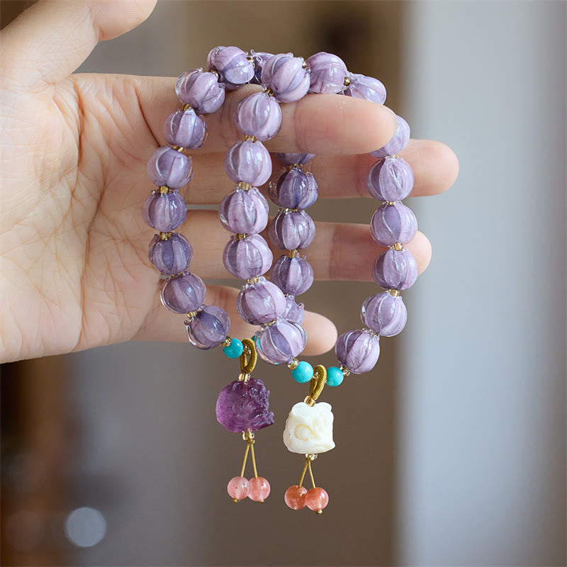 Armband Fluorit Lotus lila Perlen Türkis Blütenanhänger Handgelenk