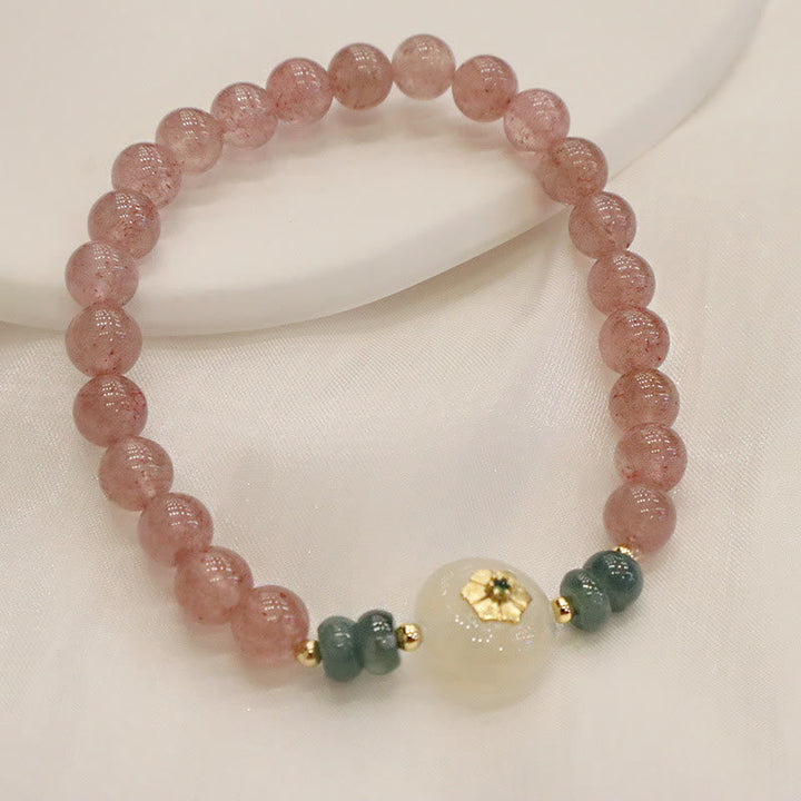 Armband Erdbeerquarz Jade Heilstein mit goldfarbenen Akzenten elastisch.