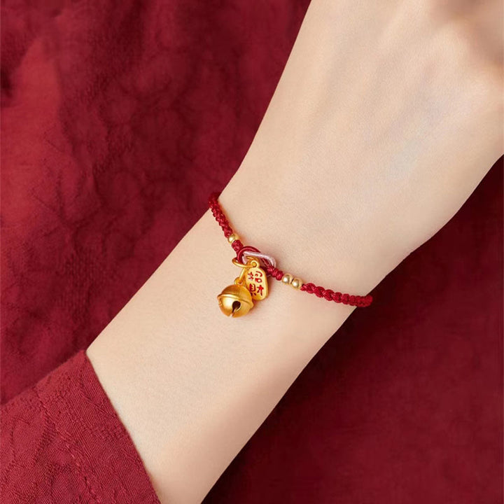 Rotes Armband mit goldenem Fu-Zeichen Glück Charm am Handgelenk.