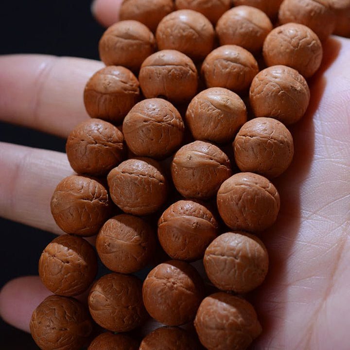 Mala Bodhi Glück Wohlstand Balance braune Holzperlen Armband Hand