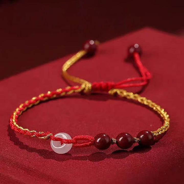 Armband Zinnober Jade mit durchsichtiger Perle elastisch rot gold