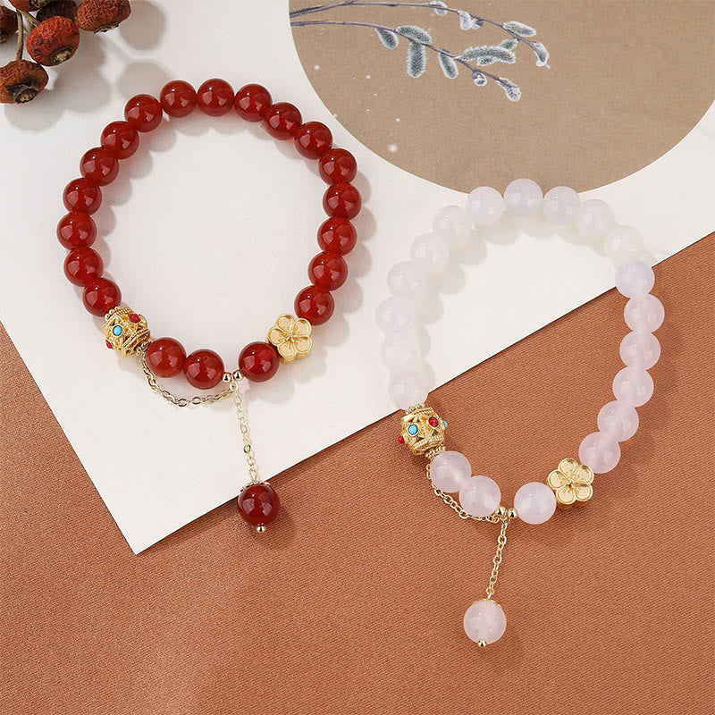 Armband Roter Achat Pfirsichblüte elastisch Naturstein golden verziert.