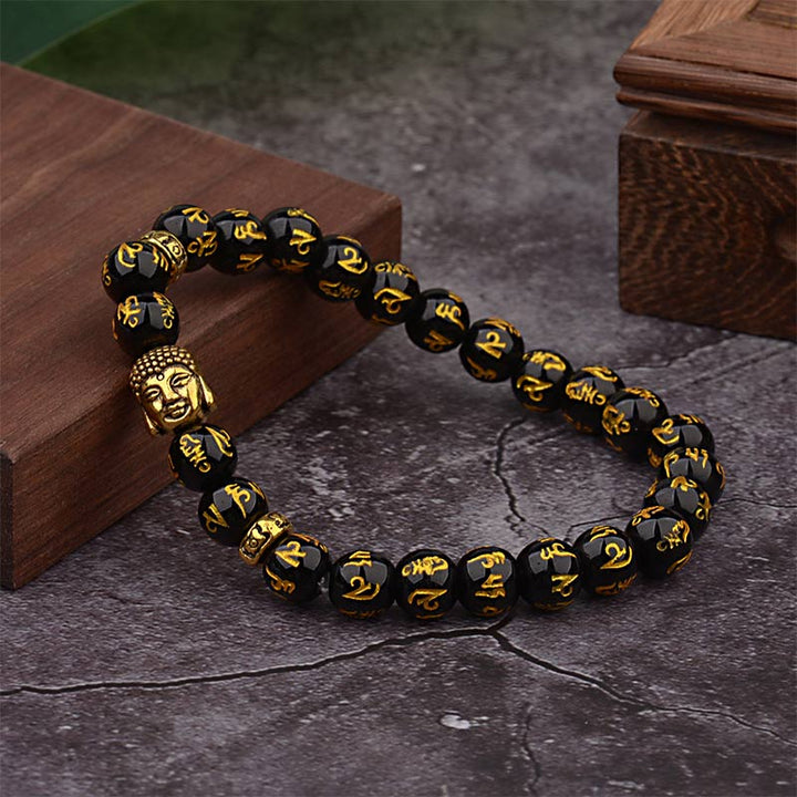 Armband Tibet Buddha Mantra Amulet schwarze Perlen goldene Gravur Holz Untergrund