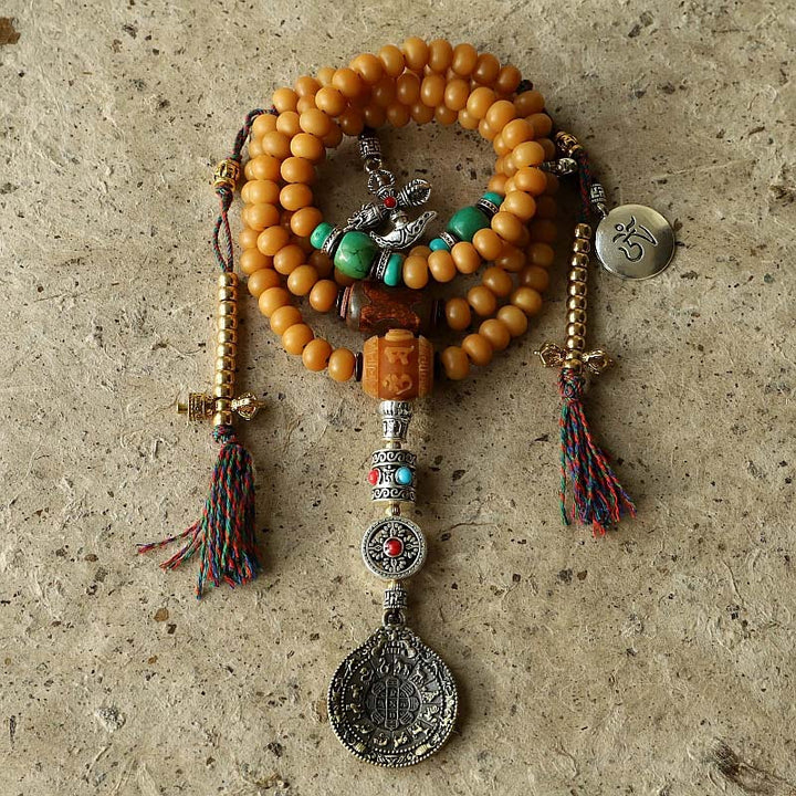 Mala Bodhi Wohlstand Energie Armband aus orangefarbenen Perlen mit Anhängern