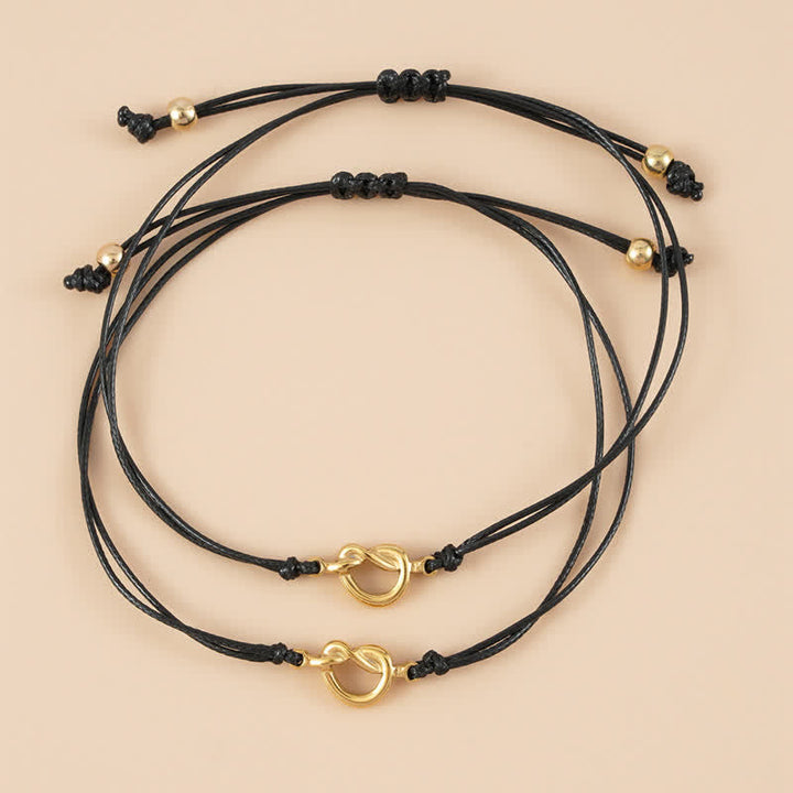 Zwei schwarze Armbänder Freundschaft Best Friend mit goldenem Herz-Anhänger.