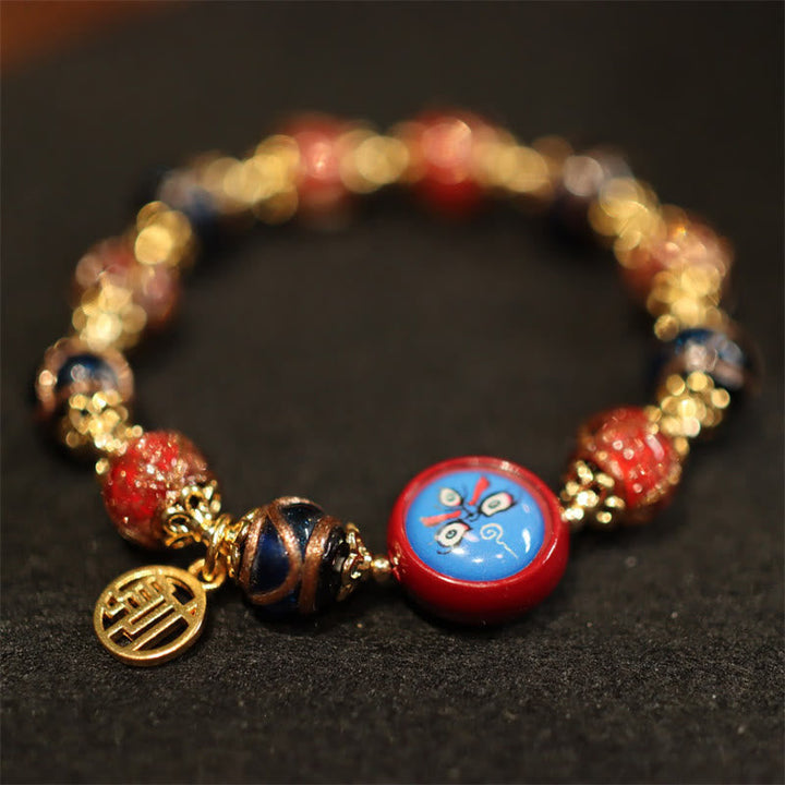 Armband – Wohlstand & Glück mit roten Perlen und goldenen Elementen.