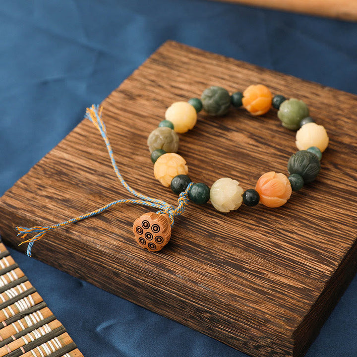 Armband Achat Bodhi Lotus mit bunten Natursteinen auf Holzplatte.
