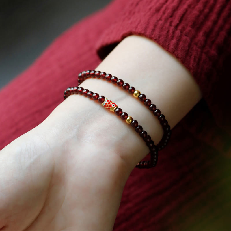 Armband Granat Koi Fisch – Schutz mit roten Perlen am Handgelenk getragen