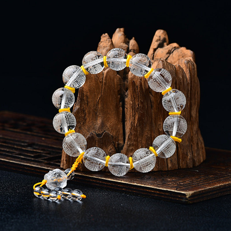 Armband Weißer Kristall Herzsutra mit gelbem Gummi elastisch.