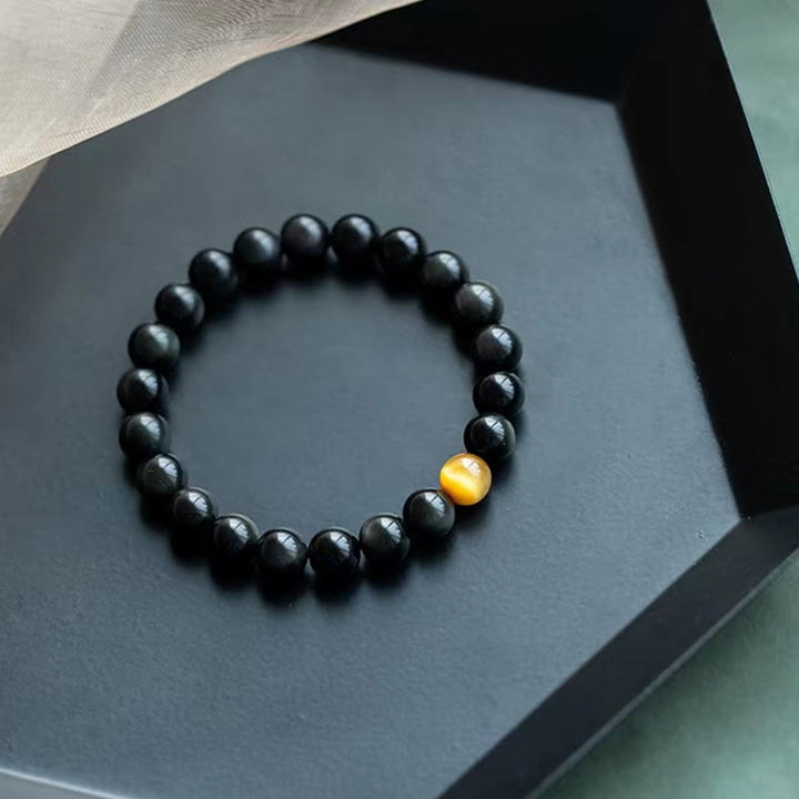 Schwarzes Obsidian Armband mit gelbem Tigerauge Stein elegant.