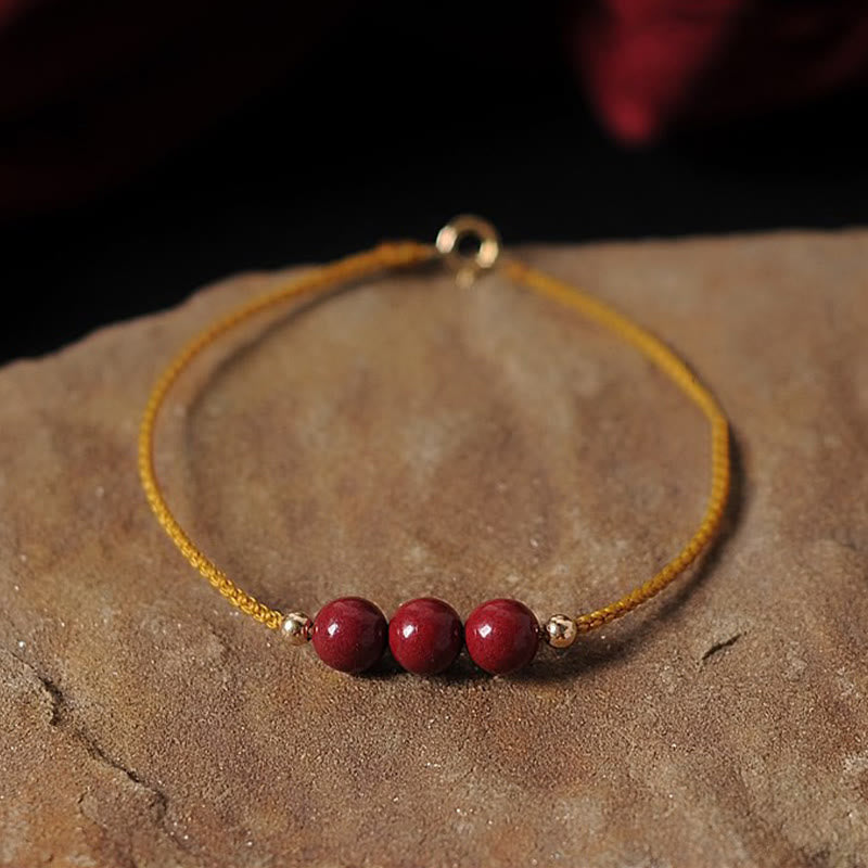 Armband Zinnober – Segen & Segen mit roten Perlen goldener Schnur