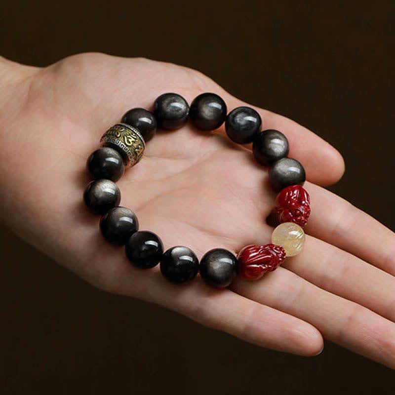 Obsidian Armband mit roten Zinnober Perlen und Om Symbol Verschluss