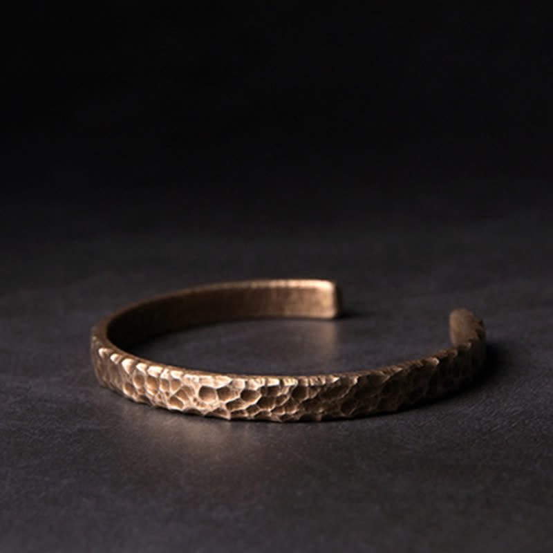Kupfer Armband mit strukturierter Oberfläche auf dunklem Hintergrund elegant.