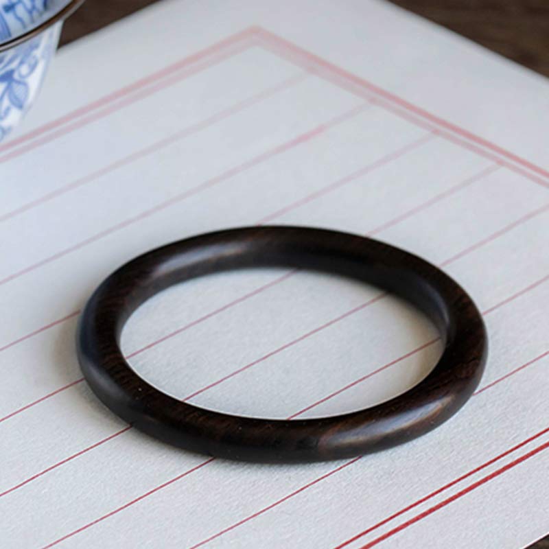 Sandelholz Ebenholz Armband dunkelbraun auf liniertem Papier Nahaufnahme