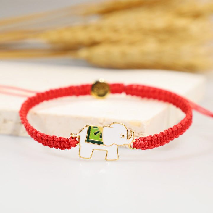 Rotes Armband mit goldenem Elefant Anhänger Glücksarmband elastisch.