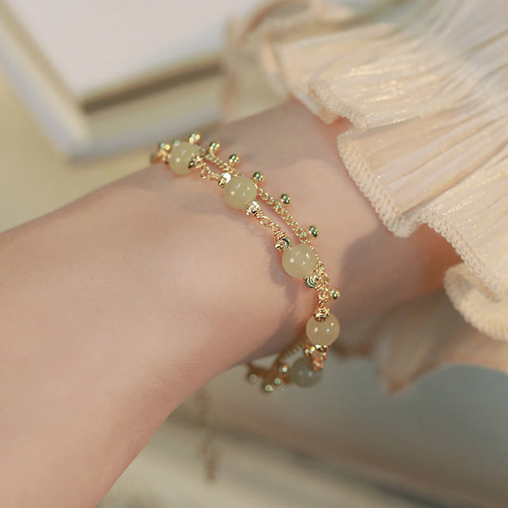Jade Armband Glück Wohlstand Harmonie goldfarben Perlen elegant Handgelenk getragen