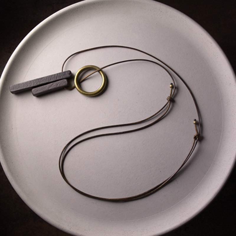 Anhänger Ebenholz Zen Kreis schwarzer Naturstein Lederband Schmuck