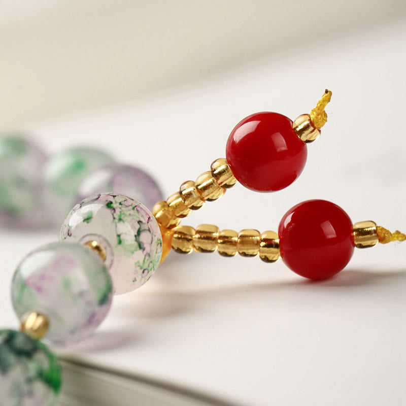 Armband – Harmonie & Segen mit roten Perlen und goldenen Elementen elegant.