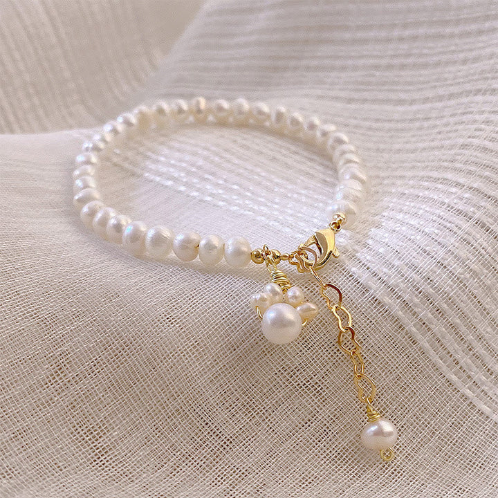 Armband Perle Katze – Heilung weiße Perlen goldene Verschlüsse elegant