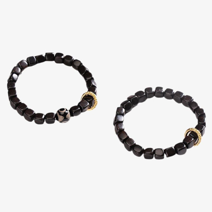 Armband Ebenholz mit goldenen Perlen Balance und Ruhe Naturstein