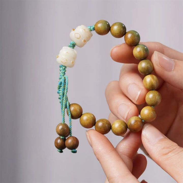 Sandelholz Bodhi Armband mit goldenen Perlen Türkis Schnur Handgelenk