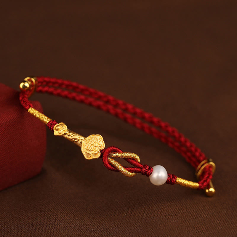 Rotes Armband Perle Fu-Zeichen Glück goldene Akzente elastisch.