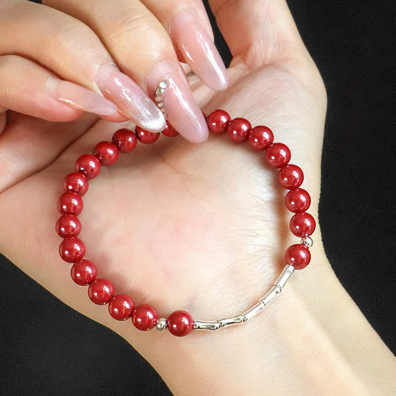Armband 925 Silber Zinnober Ruhe Energie rote Perlen am Handgelenk getragen
