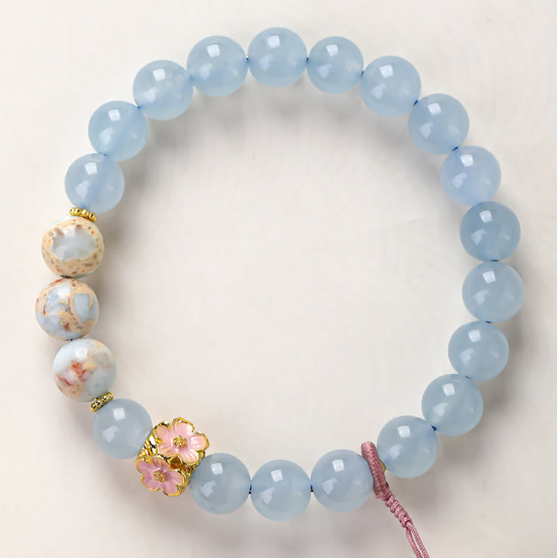 Armband Chalcedon Fu-Zeichen Heilung hellblaue Perlen Kirschblüte goldene Verzierung Handgelenk